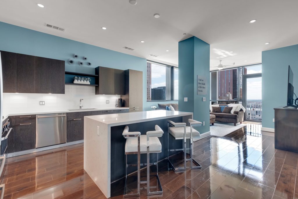 Modern high-rise condo kitchen with breakfast bar