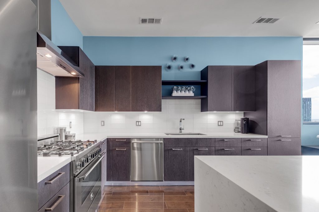 Modern condo kitchen with gas cooktop and dark cabinetry
