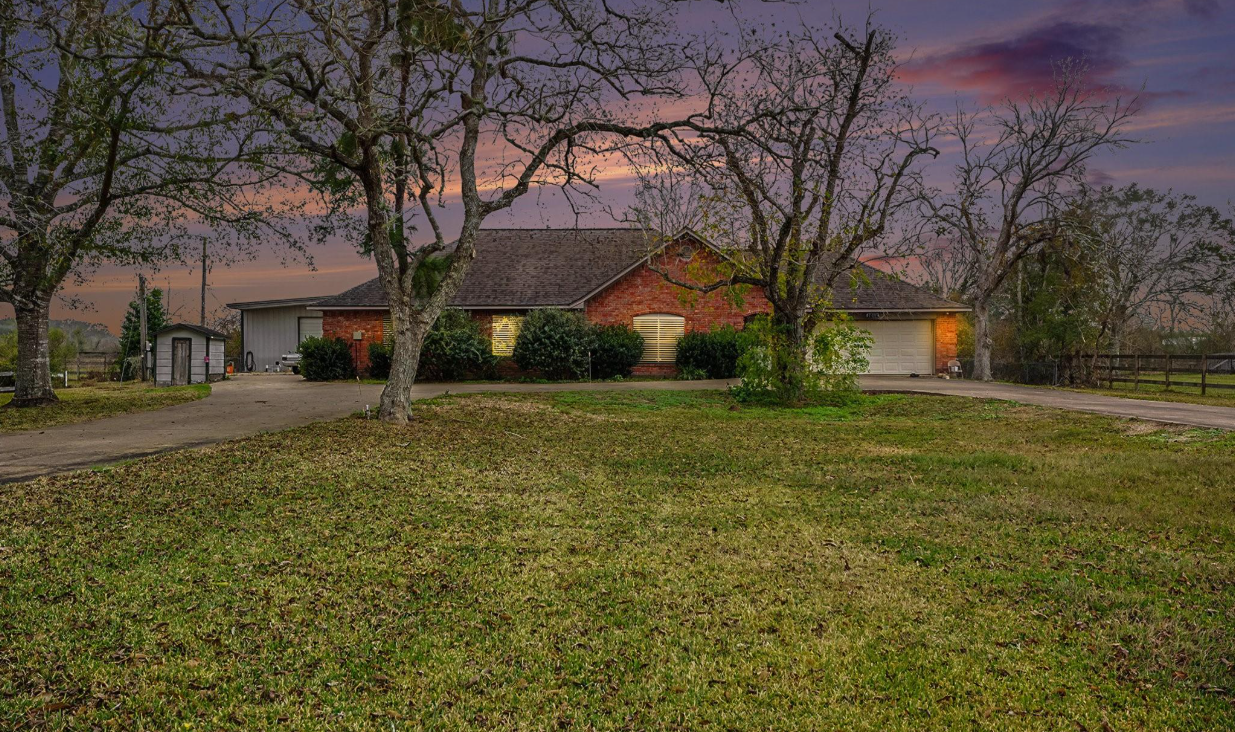 Brick ranch home on a large lot under mature oak trees