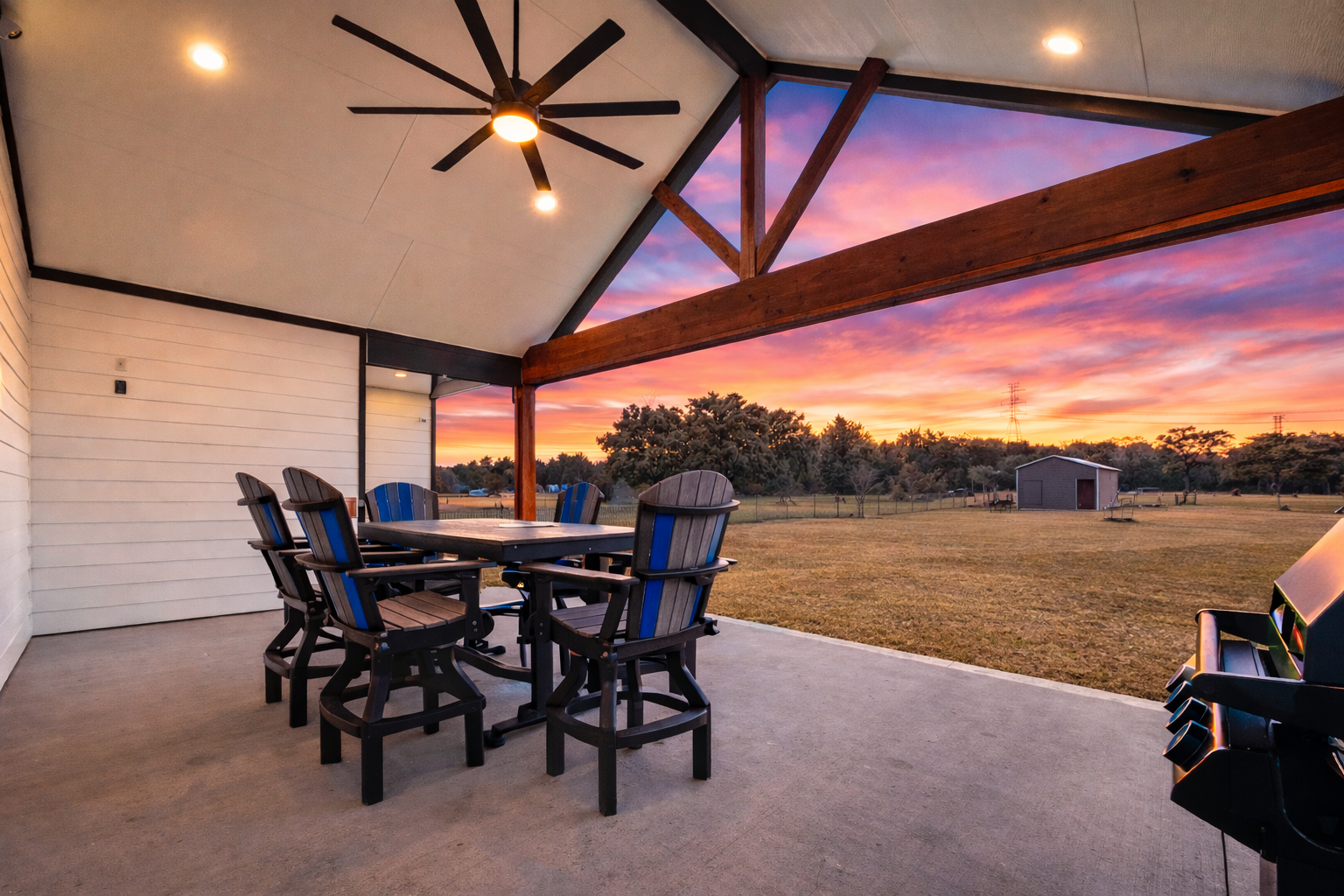 Covered patio at sunset overlooking open acreage